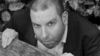Ed Gaughan - actor peering over a piece of wood